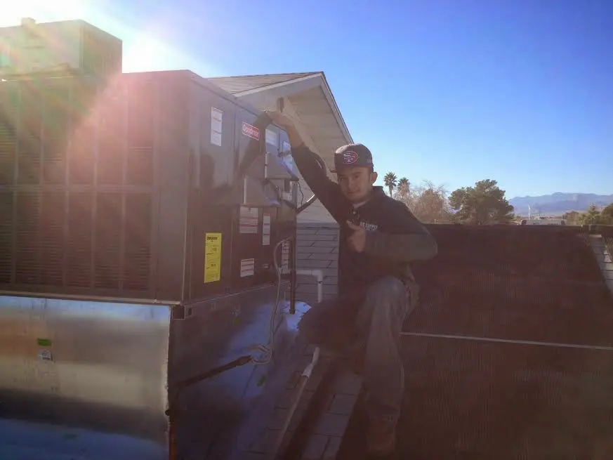 HVAC technician performing Boiler Repair on a rooftop unit in Mullica